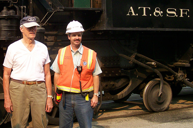 Director/actor Clint Eastwood, left, was on location for filming of The Changeling. Bob Brendza, now general director, Network Control Systems for BNSF, assisted in the operating plan. Director/actor Clint Eastwood, left, was on location for filming of The Changeling. Bob Brendza, now general director, Network Control Systems for BNSF, assisted in the operating plan.