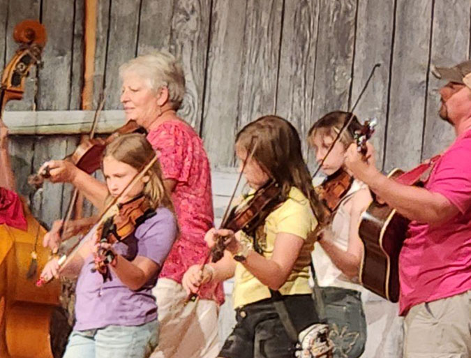 Jayne Huguenin (in purple) jams with fellow fiddlers Jayne Huguenin (in purple) jams with fellow fiddlers