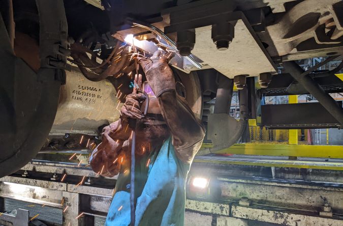 A machinist at our Topeka shop attaches the prototype ODIN to a locomotive for testing. A machinist at our Topeka shop attaches the prototype ODIN to a locomotive for testing.