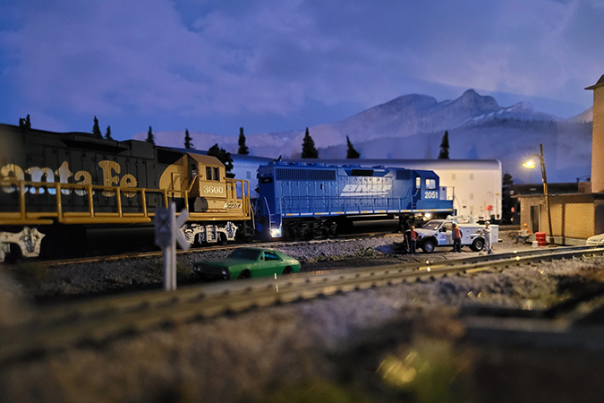 A blue BNSF locomotive railfans call the “Smurf” and Santa Fe “Yellow Bonnet” make an early night service stop. A blue BNSF locomotive railfans call the “Smurf” and Santa Fe “Yellow Bonnet” make an early night service stop.