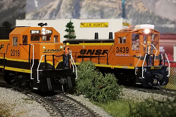Crew members on two stopped locomotives have an impromptu meeting. Crew members on two stopped locomotives have an impromptu meeting.