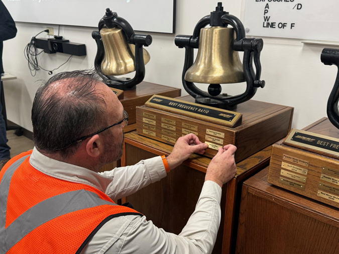Engineer and Safety Leader Steve Mullen applies the Powder River Division 2025 plaque on the Safety Bell. Engineer and Safety Leader Steve Mullen applies the Powder River Division 2025 plaque on the Safety Bell.