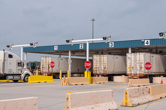 Outbound trucks leave the facility, which will see even more activity during peak season. Outbound trucks leave the facility, which will see even more activity during peak season.
